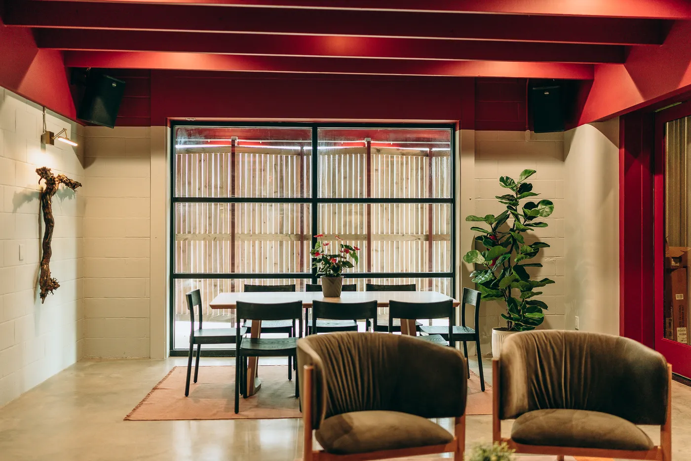 A private dining table set for a meeting, looking out to the patio